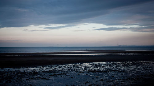 Scenic view of sea against sky at sunset