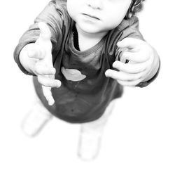 High angle view of girl wearing mask against white background