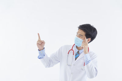 Midsection of person wearing hat standing against white background