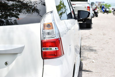 Close-up of car on road in city