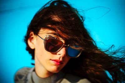 Close-up portrait of young woman wearing sunglasses