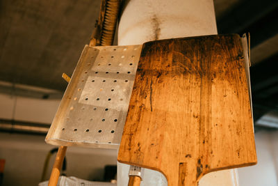 Cropped hand of woman standing against wall