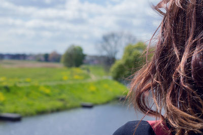 Cropped image of woman's hair against sky