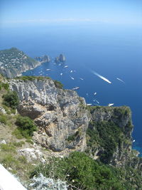 High angle view of rocks by sea against sky