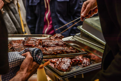 Low angle view of man with grilled meat in tray