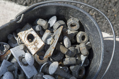 Directly above shot of nuts and bolts in metallic container