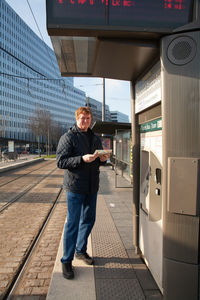 Full length portrait of young man standing outdoors