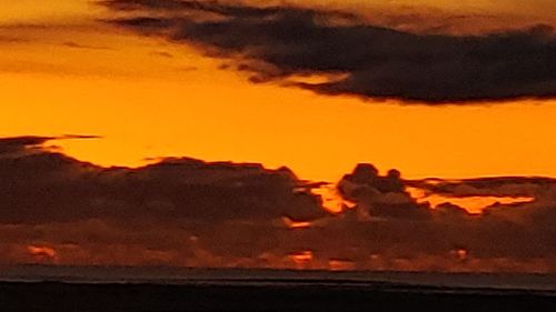 Scenic view of dramatic sky over sea during sunset