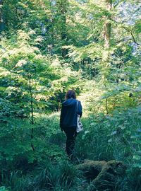 Full length of woman standing in forest