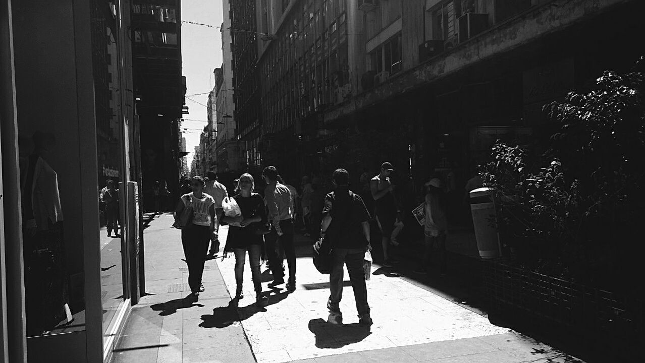 WOMAN WALKING ON CITY STREET