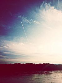 Scenic view of vapor trails against sky during sunset