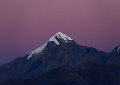 Scenic view of snowcapped mountains against clear sky during winter