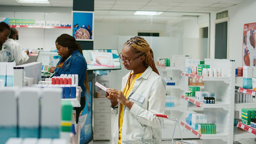 Portrait of female friends standing in laboratory