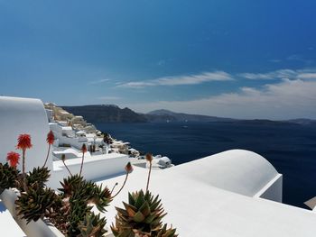 Town and seascape against sky