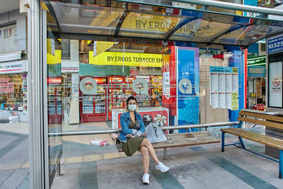 Woman sitting on seat in store