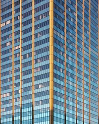 Low angle view of modern building against blue sky