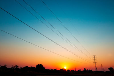 Silhouette trees against sky during sunset