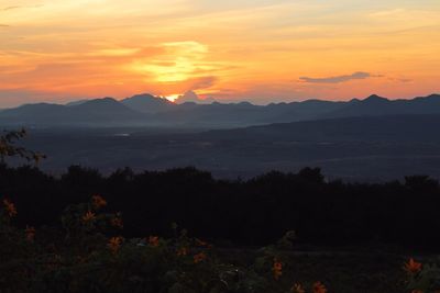 Scenic view of silhouette mountains against sky during sunset