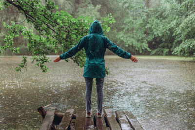 Full length rear view of man standing in river