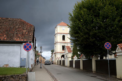 Road amidst buildings against sky in city