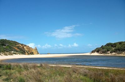 View of beach against blue sky