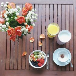 Directly above shot of breakfast and flower vase on table