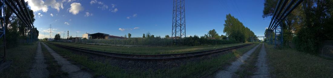 Panoramic view of railroad tracks amidst buildings against sky