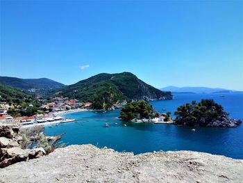 Scenic view of bay against clear blue sky