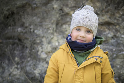 Cute caucasian boy is smiling and making a funny face to the camera