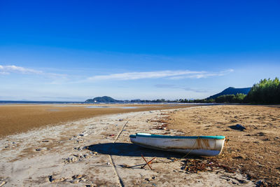 Scenic view of beach against blue sky