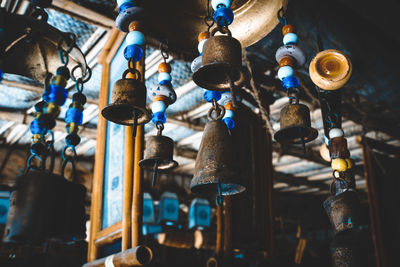 Low angle view of bell hanging at market stall