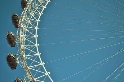 Low angle view of ferris wheel against sky