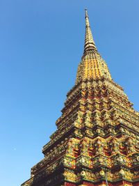 Low angle view of temple against clear blue sky