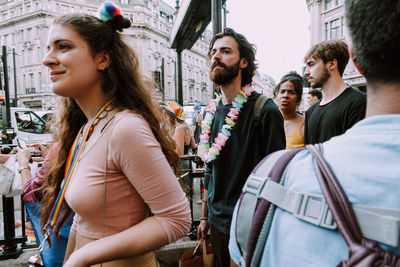 Women looking at people in city