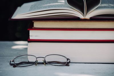 Close-up of books and eyeglasses on table