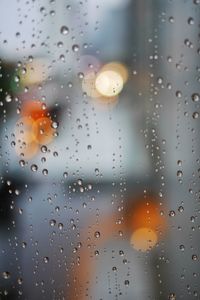 Full frame shot of wet glass window in rainy season