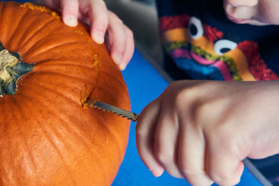 Midsection of woman holding pumpkin