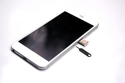 High angle view of smart phone on white background