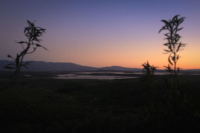 Scenic view of field against sky during sunset