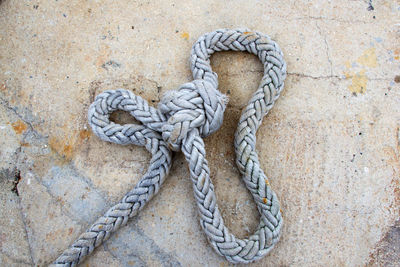 High angle view of rope tied on metal