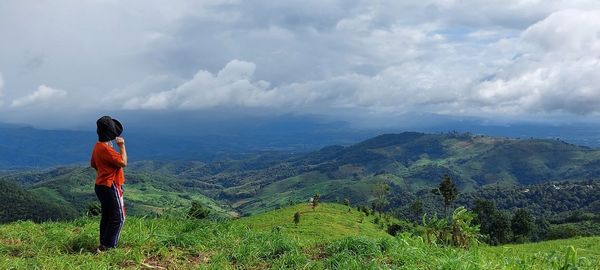 Man standing on landscape against sky