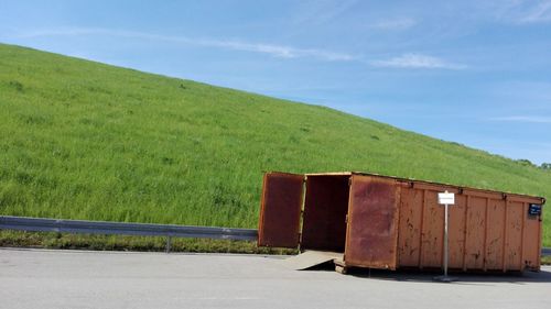 Built structure on field against sky