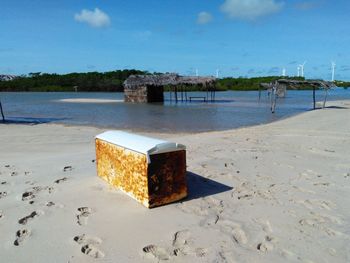 Lifeguard hut on beach against sky