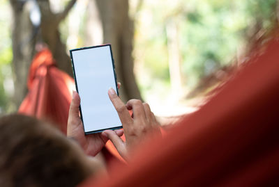 Midsection of woman using mobile phone