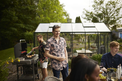 Friends having barbecue in garden