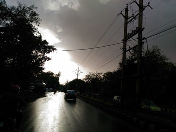 Cars on road at sunset