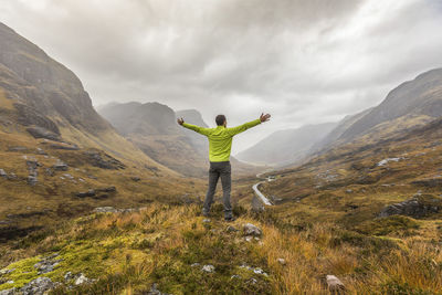 Uk, scotland, man in the scottish highlands near glencoe with a view on the three sisters