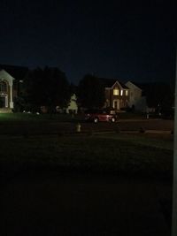 Houses against clear sky at night