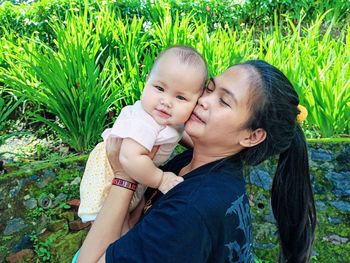 Mother and daughter against plants