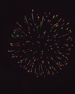 Low angle view of firework display against sky at night